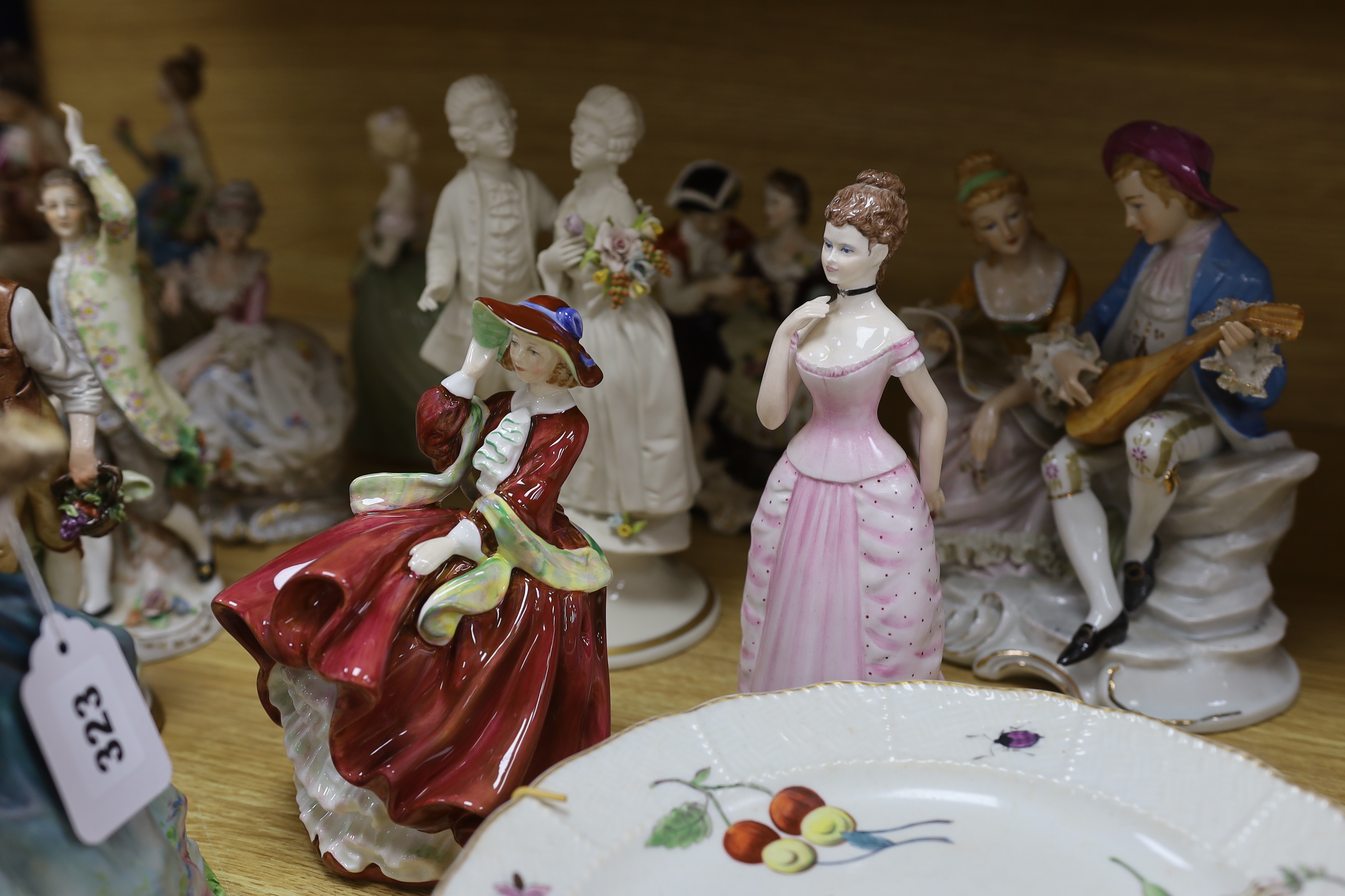 A collection of various porcelain figures including Coalport, Doulton etc. and two dessert plates